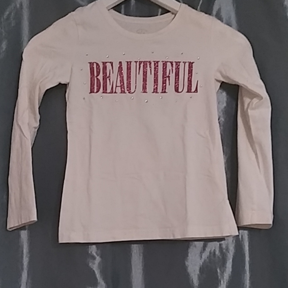 A white long sleeve shirt with "beautiful" on it
